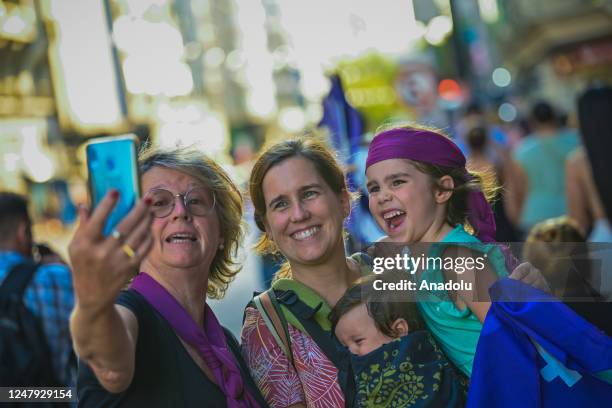 Grandmother, mother and two little girls take a selfie as thousands of women march in a demonstration for International Womenâs Day in Montevideo,...