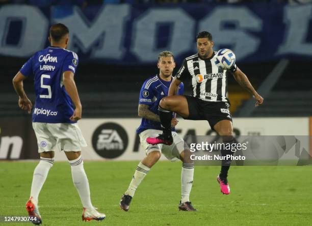 Juan Pablo Vargas of Millonarios FC and Hulk of CA Mineiro of Brazil dispute the ball in the Copa Libertadores phase 3 played at the Nemesio Camacho...