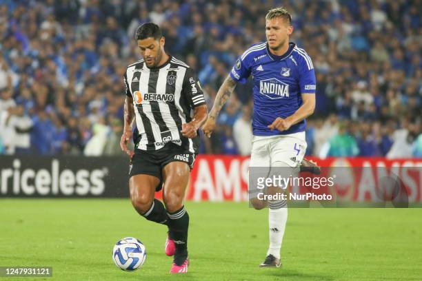 Juan Pablo Vargas of Millonarios FC and Hulk of CA Mineiro of Brazil dispute the ball for the Copa Libertadores phase 3 played at the Nemesio Camacho...
