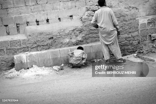 Pakistan-society-children-sex,FEATURE" BY HASAN MANSOOR Pakistani street child Rizwan abused by a policeman, urinates on a street in Karachi on July...