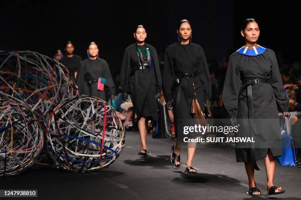 Models present creations by Chamar during the Lakmé Fashion Week x FDCI, in Mumbai on March 9, 2023. / -- IMAGE RESTRICTED TO EDITORIAL USE -...
