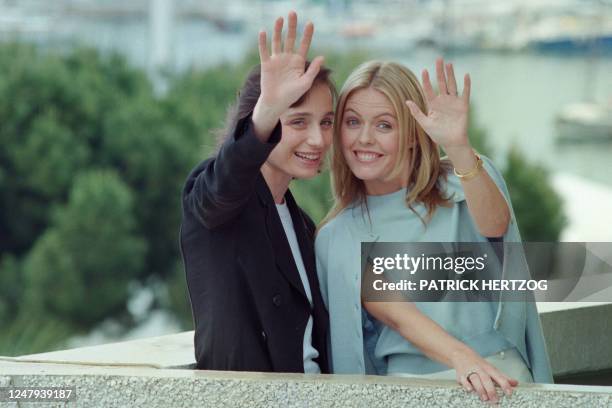 British actresses Kristin Scott Thomas and Patsy Kensit greet the photographers before the press presentation of their film "Angels and Insects"...