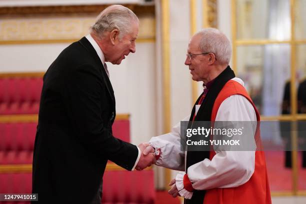 Britain's King Charles III shakes hands with the Archbishop of Canterbury, Justin Welby during a presentation of loyal addresses by the privileged...