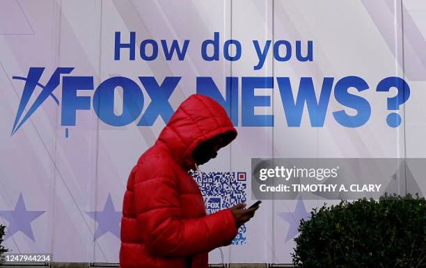 Person walks past the Fox News Headquarters at the News Corporation building in New York City March 9, 2023. - Dominion Voting Systems is suing Fox...