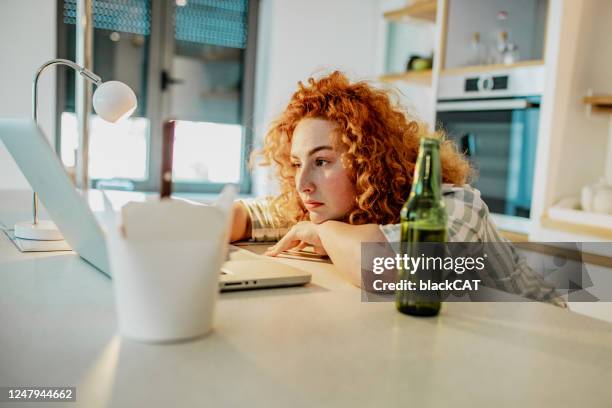 young woman is overworked at home - stress eating stock pictures, royalty-free photos & images