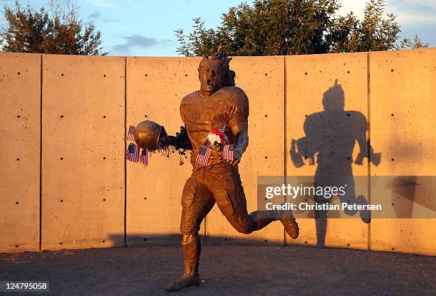 Fans adorn the Pat Tillman statue with American flags in honor of the 10 year anniversary of the 9/11 attacks following the NFL season opening game...