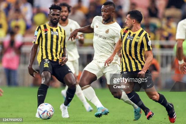 Ittihad's Egyptian midfielder Tarek Hamed vies for the ball against Nassr's Ivorian defender Ghislain Konan during the Saudi Pro League football...
