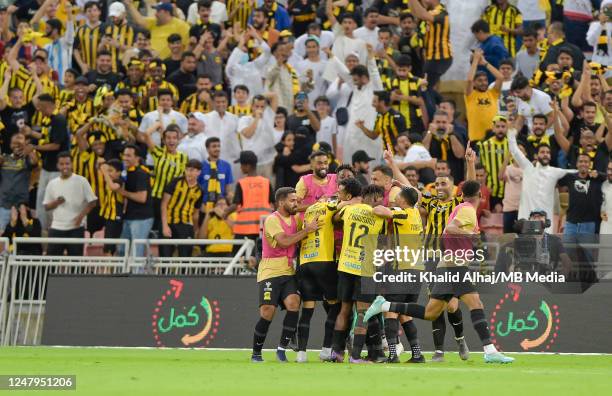 Romarinho of Al Ittihad celebrates with his team-mates after scoring his sides first goal during the Saudi Pro League match between Al Ittihad and Al...