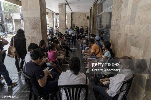 Residents wait in line outside of the state-controlled Banco Union branch in Santa Cruz de la Sierra, Bolivia, on Thursday, March 9, 2023....