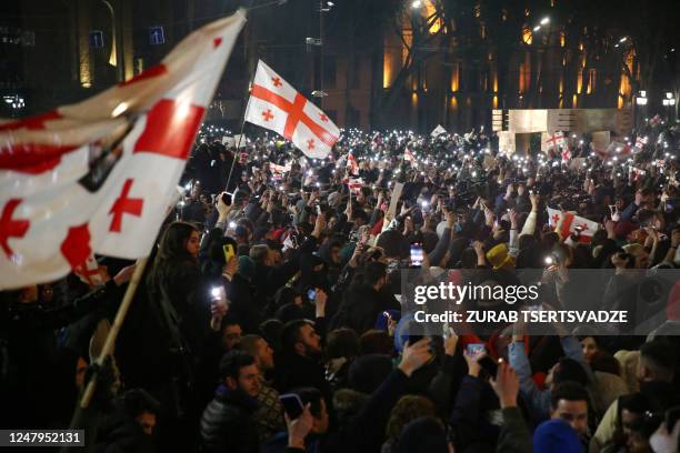 Georgian opposition supporters rally calling for government to follow 'pro-Western' path, outside the parliament in Tbilisi on March 9, 2023. -...