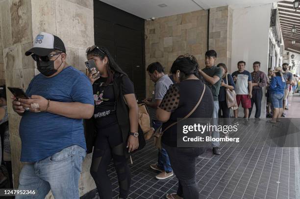 Residents wait in line outside of the state-controlled Banco Union branch in Santa Cruz de la Sierra, Bolivia, on Thursday, March 9, 2023....
