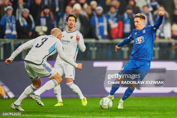 Djurgardens IF's Swedish defender Marcus Danielsson and Lech Poznan's Polish midfielder Radoslaw Murawski vie for the ball during the UEFA Europa...