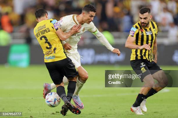 Ittihad's Egyptian midfielder Tarek Hamed and Brazilian midfielder Bruno Henrique vie for the ball against Nassr's Portuguese forward Cristiano...