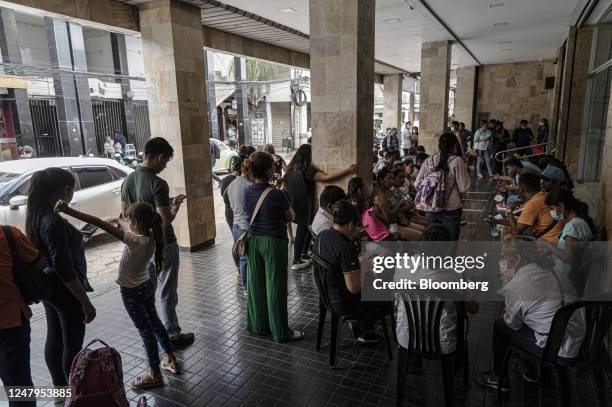 Residents wait in line outside of the state-controlled Banco Union branch in Santa Cruz de la Sierra, Bolivia, on Thursday, March 9, 2023....