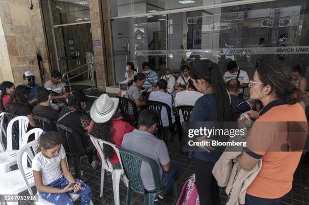 Residents wait in line outside of the state-controlled Banco Union branch in Santa Cruz de la Sierra, Bolivia, on Thursday, March 9, 2023....