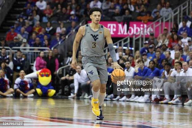 West Virginia Mountaineers forward Tre Mitchell brings the ball up court in the second half of a Big 12 Tournament quarterfinal basketball game...