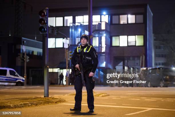 Police officers attend at the scene of a shooting that has left at least six people dead and four wounded in Alsterdorf district, on March 9, 2023 in...