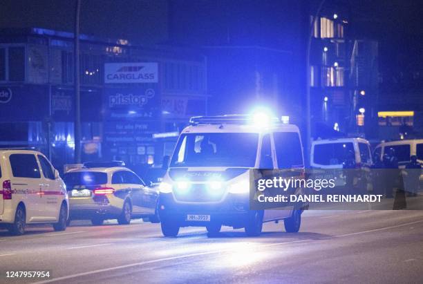 Police cars are standing near a Jehovah's Witness church where several people have been killed in a shooting in Hamburg, northern Germany, on late...