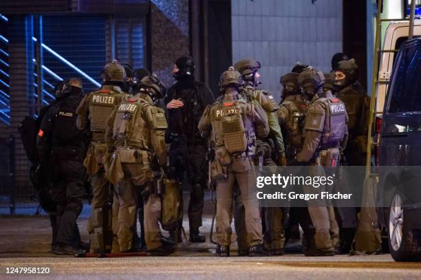 Police officers gather at the scene of a shooting that has left at least six people dead and four wounded in Alsterdorf district, on March 9, 2023 in...