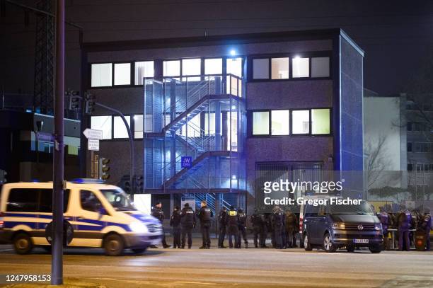 Police officers gather at the scene of a shooting that has left at least six people dead and four wounded in Alsterdorf district, on March 9, 2023 in...