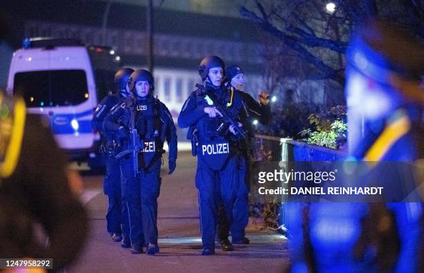 Heavily armed police inspect the area near a Jehovah's Witness church where several people have been killed in a shooting in Hamburg, northern...