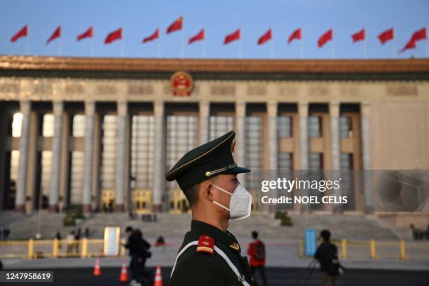 Security officer stands guard outside the Great Hall of the People in Beijing on March 10, 2023 ahead of the third plenary session of the National...