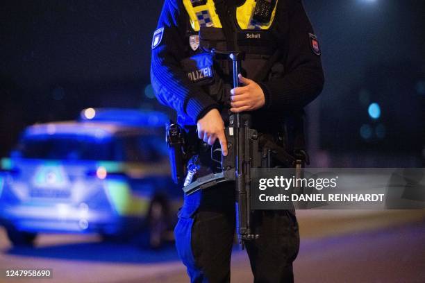 Heavily armed police inspect the area near a Jehovah's Witness church where several people have been killed in a shooting in Hamburg, northern...