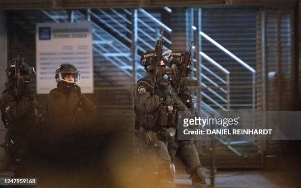 Armed police patrol outside a Jehovah's Witnesses church where several people have been killed in a shooting in Hamburg, northern Germany, on late...