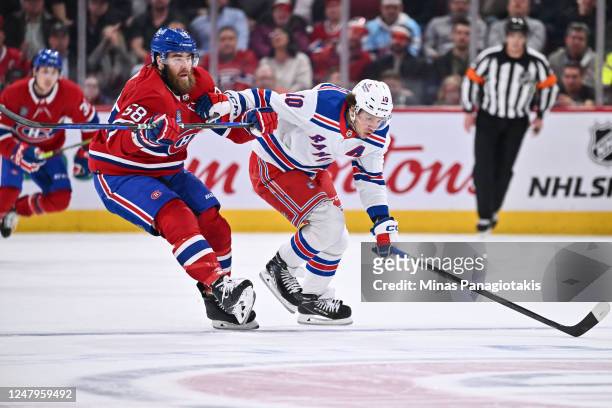 David Savard of the Montreal Canadiens and Artemi Panarin of the New York Rangers skate against each other during the first period at Centre Bell on...