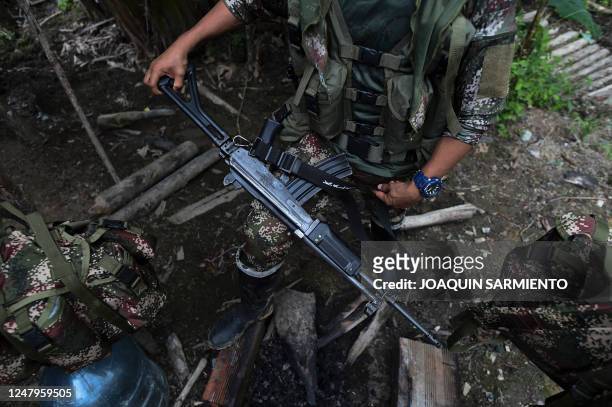 Dissident guerrilla fighter from the FARC-EP Rafael Aguilera gets ready to go out on a patrol in the jungle at a camp in the Colombian department of...