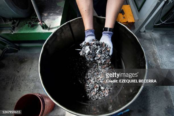 Worker at Fortech company shows metals recycled from electric car batteries in Cartago, Costa Rica,on February 20, 2023. - The Fortech company in...