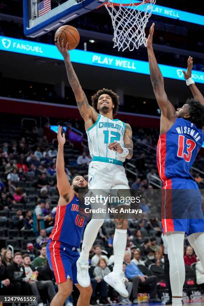 Kelly Oubre Jr. #12 of the Charlotte Hornets shoots the ball against Cory Joseph of the Detroit Pistons and R.J. Hampton of the Detroit Pistons...