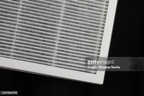 disposable air filter on a black background - air purifier fotografías e imágenes de stock