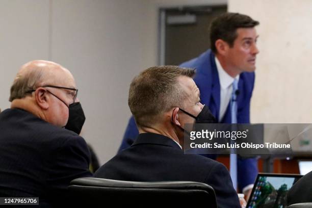 Prosecutor Chris Puervelle puts a slide on a projection screen as defense attorney Paul Sanger, left, and defendant Paul Flores look on in Monterey...