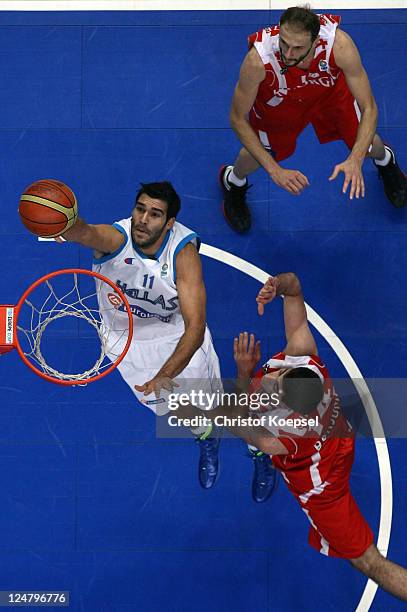 Dimitrios Mavroeidis of Greece shoots over Viktor Sanikidze of Georgia and Tomike Shengelia of Georgia during the EuroBasket 2011 second round group...