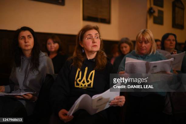 Displaced and London-based Ukrainians sing during a rehearsal for the Royal Opera Chorus at St Pauls church in central London on March 8, 2023. - In...
