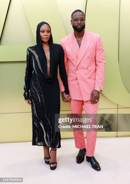 Actress Gabrielle Union and her husband retired pro-basketball player Dwyane Wade arrive for the Versace Fall/Winter 2023 fashion show on March 9 at...