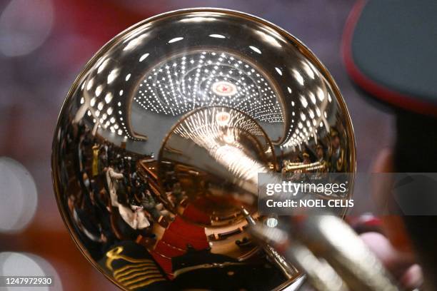 Reflection of the inside view of the Great Hall of the People is seen on a trombone during the third plenary session of the National People's...