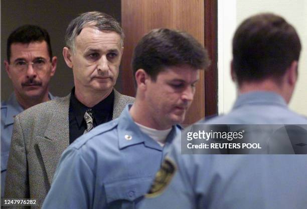 Bosnian Serb General Radislav Krstic is escorted into the court room at the International war crimes tribunal for the former Yugoslavia in The Hague...