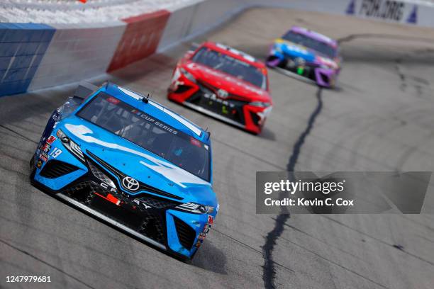 Martin Truex Jr., driver of the Auto Owners Insurance Toyota, leads a pack of cars during the NASCAR Cup Series Folds of Honor QuikTrip 500 at...