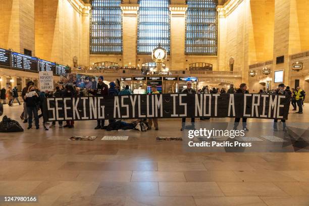 Members of the Rise and Resist movement rally at Grand Central Terminal in New York against Title 42 which they believe is being used to deprive...