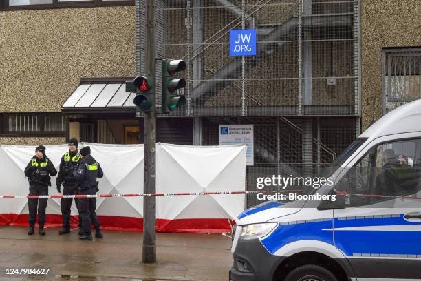 Police officers outside the Jehovah's Witnesses church, where several people died and others were injured in a shooting the previous evening, in...