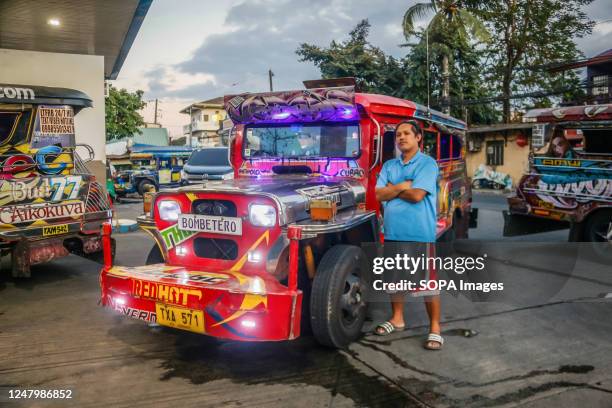 Mark stands next to his traditional jeepney and poses for a photo in Metro Manila. Philippine government is pushing its Public Utility Vehicle...