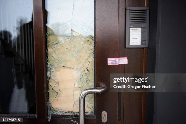 Smashed door is seen on a building where a shooting the night before left at least eight people dead and eight more wounded in Alsterdorf district on...