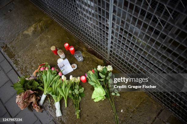 Flowers and candles put down by people are seen in front of a building where a shooting the night before left at least eight people dead and eight...