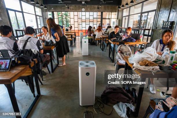 College students use air purifiers to reduce air pollution at a learning space of the faculty of Mass Communication in Chiang Mai University amid...