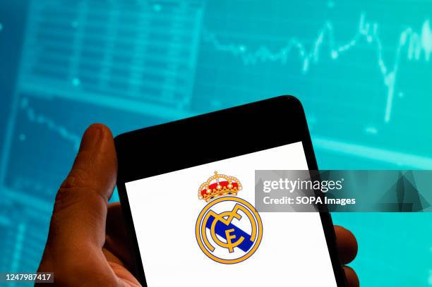 In this photo illustration, the Spanish professional football club team Real Madrid Club de Fútbol commonly known as the Real Madrid logo is seen...