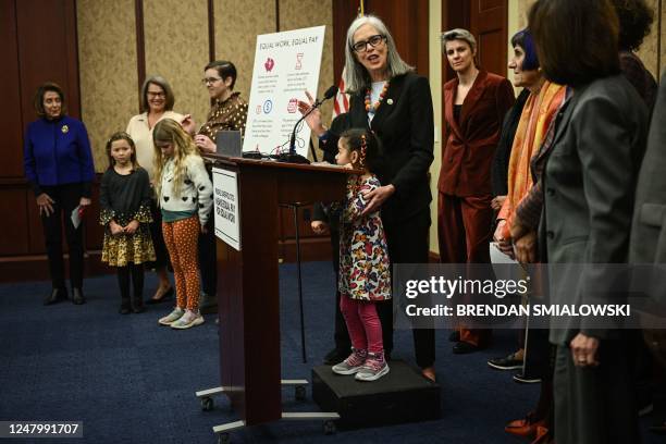 Pherabe, the daughter of Brooke Scannell, stands with her mothers boss, US Rep. Katherine Clark, Democrat from Massachusetts, as she speaks during a...