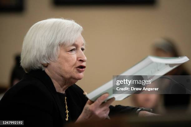 Treasury Secretary Janet Yellen holds up a copy of the Treasury Departments Greenbook as she testifies during a House Ways and Means Committee...