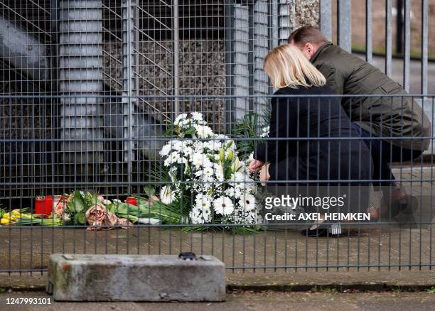 German Interior Minister Nancy Faeser and Hamburg's Interior Senator Andy Grote knee over flowers at the tatort where several people were killed in a...